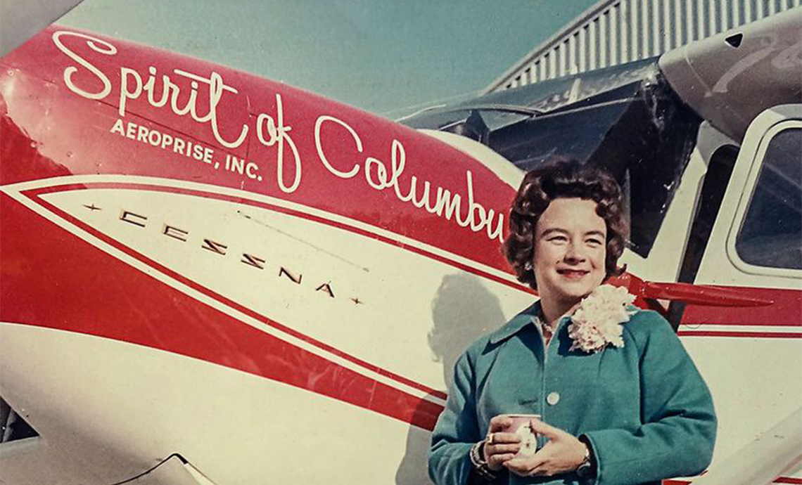 Image of pilot Jerrie Mock standing in front of her airplane Spirit of Columbus